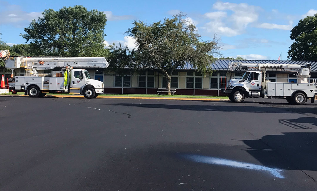 valiant-bucket-truckin-front-of-school