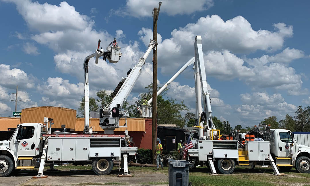 valiant bucket trucks repairing damaged powerlines in town
