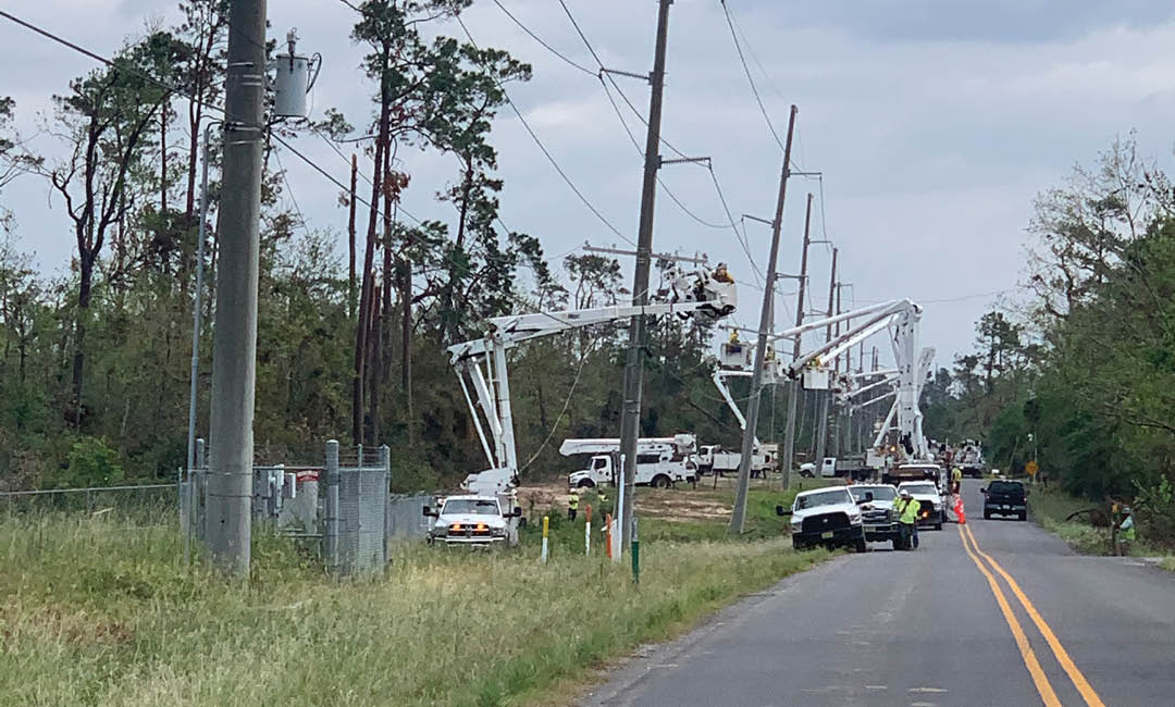 valiant bucket trucks working on side of road